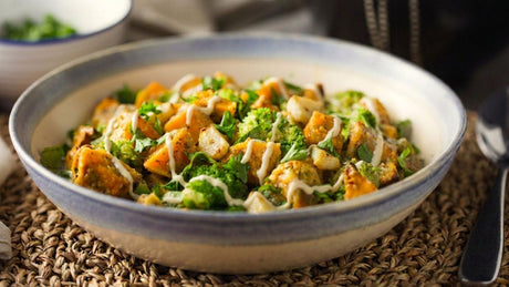 Roasted sweet potatoes and broccoli with roasted garlic, parsley, and a light tahini drizzle