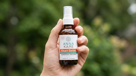 Klean Detox 60 ml spray bottle held in hand outdoors